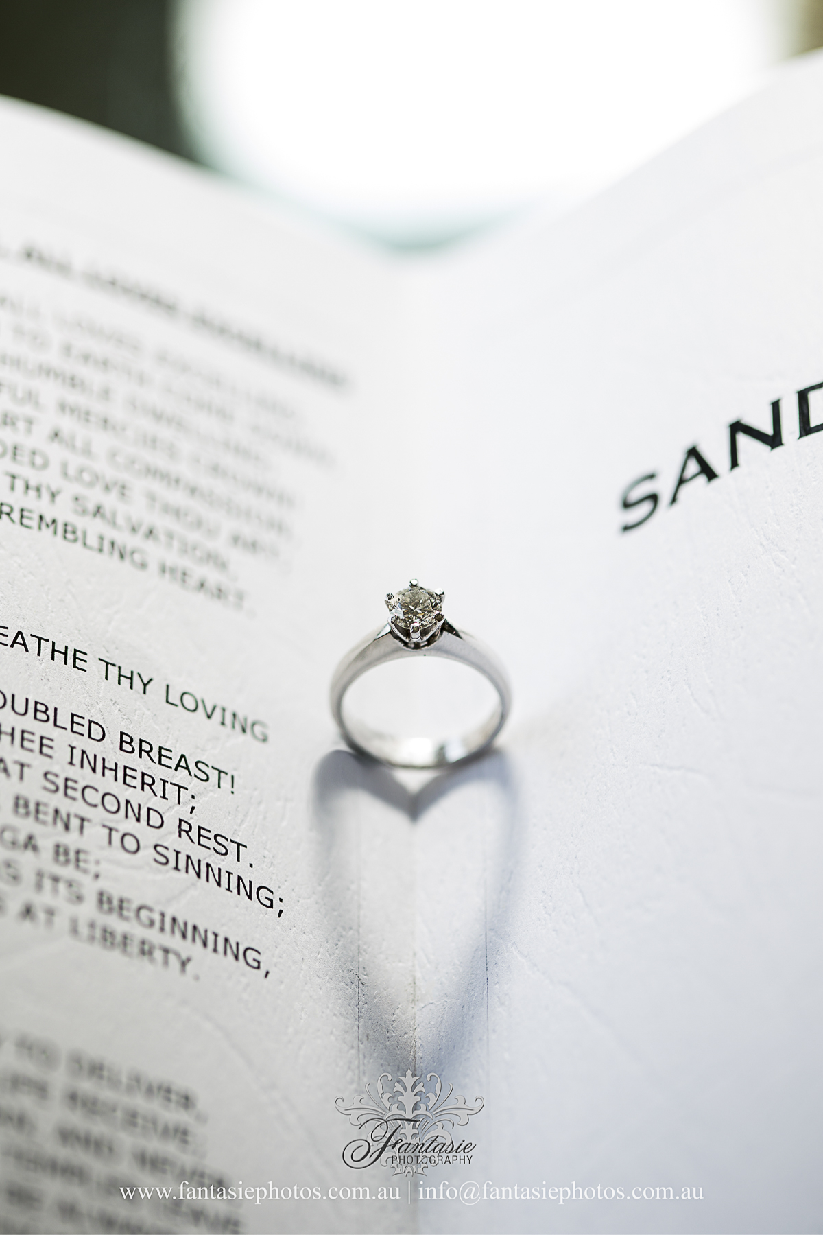 Love heart wedding engagement diamond ring in the book photo | Fantasie Photography