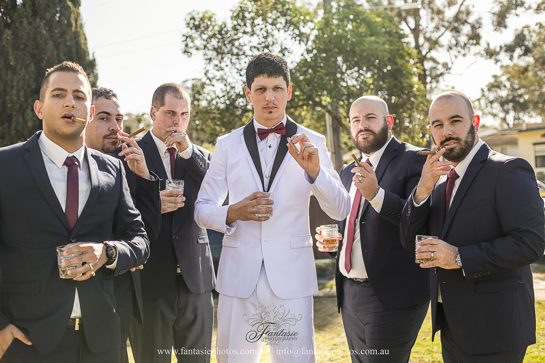 Wedding Photography | Grooms & Groomsmen Lighting up their cigars | Fantasie Photography