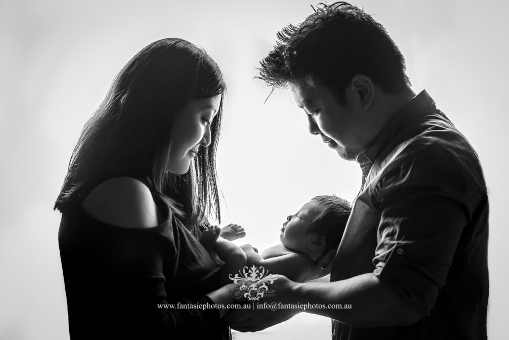 japanese and Korean parents holding their baby under the flash light - Wedding Photography, Newborn and Family Portrait | Fantasie Photography