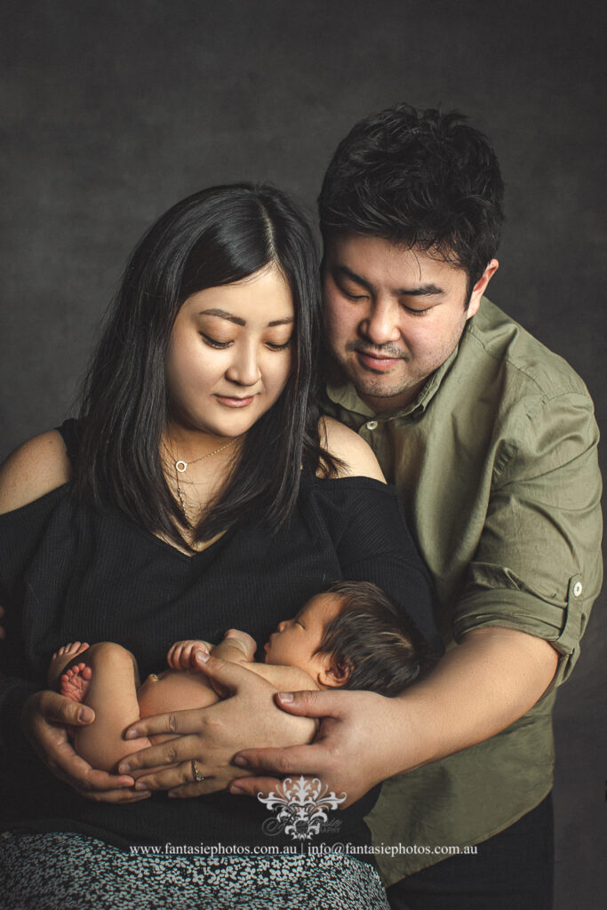Japanese and Korean parents holding the newborn baby - Wedding Photography, Newborn and Family Portrait | Fantasie Photography